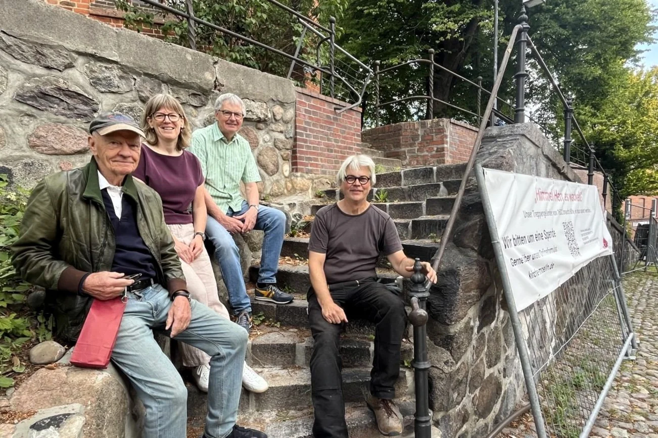 Großspender Hans Jürgen Ohff, Pastorin Hilke Lage, Gerhard Motten vom Kirchengemeinderat und Restaurator Peter Eingrüber am historischen Treppengeländer an der Möllner St.-Nicolai-Kirche.