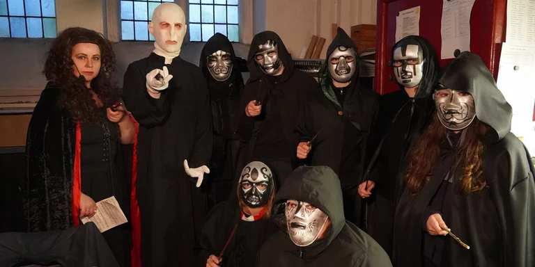 Eine Gruppe düster Verkleideter Darsteller mit gruseligen Masken.