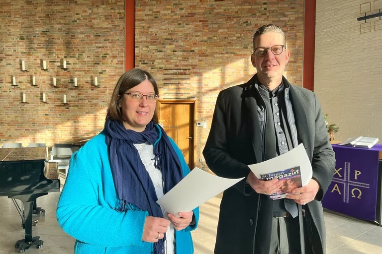 Zwei Personen stehen in einer Kirche